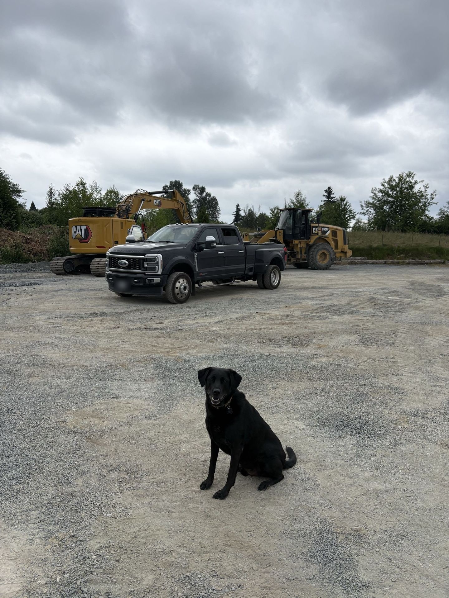 The JMEX crew truck with a Cat excavator and wheel loader on the yard
